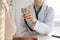 Doctor with a stethoscope in the hand. Physician examines her female patient.