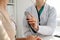 Doctor with a stethoscope in the hand. Physician examines her female patient.