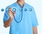 Doctor with stethoscope and informational icons on light background. Medical service