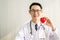 Doctor with stethoscope showing red heart at hospital office, Medical health care and doctor staff service concept