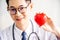 Doctor with stethoscope showing red heart at hospital office, Medical health care and doctor staff service concept