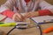 Doctor with stethoscope sitting at a desk, writing something, prescription or recommendation of the patient, the photo