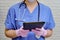 A doctor with a stethoscope works remotely via the Internet in a tablet. A nurse in a blue uniform holds a digital tablet in a