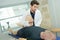Doctor stretching mans leg on physiotherapy session