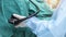 A doctor or surgeon in a light blue protective gown did a colonoscopy or gastroscopy inside operating theatre in the hospital.