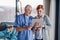 Doctor with tablet talking to mother of small hospitalized girl in hospital.