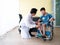 Doctor take care of child patient while checking joint and knee symptom for recovery physical body in the hospital