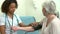 Doctor Taking Senior Female Patient\'s Blood Pressure