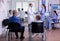 Doctor talking with nurse with face masks holding clipboard