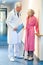 Doctor talking to an elderly woman in the corridor.