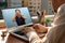 Doctor talks to his patient via telemedicine during the coronavirus pandemic at his front-to-window residence