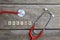 Doctor text word made with wood blocks and Red Heart,stethoscope on wooden table