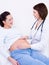 Doctor touches the belly\'s pregnant