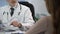 Doctor typing patient\'s data on tablet, keeping medical records, consultation