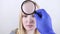 The doctor uses a magnifying glass to examine dry skin. Patient at the appointment of a dermatologist or cosmetologist, selection