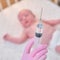 The doctor uses a syringe to inject a newborn child. A nurse in uniform is preparing to vaccinate a child