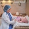 The doctor uses a syringe to inject a newborn child. A nurse in uniform is preparing to vaccinate a child