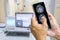 The doctor is using a cell phone to check the patient`s brain MRI results. The background is an electromagnetic control room.