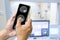 The doctor is using a cell phone to check the patient`s brain MRI results. The background is an electromagnetic control room.