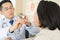 Doctor using flashlight to examination in throat of patient in the hospital room to diagnosis disease