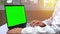 Doctor using laptop touchpad, notebook with a green screen chroma key