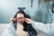 a doctor is using measuring glasses to a female patient