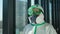 Doctor virologist scientist in mask, PPE personal protective equipment suit hospital clinic.