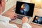 Doctor watching a laptop with x-ray of skull with pain relief in the front of the head in a medical office. Migraine concept