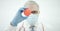 Doctor wearing face mask holds coronavirus ball model, conceptual close-up shot