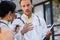 doctor in white coat holding clipboard