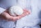 Doctor in white coat holds in his hand in palm of anatomical model of human brain. Concept photo of diagnosis, treatment and preve