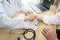 Doctor in white coat taking and checking the patient`s wrist pulse during the examination diagnosis in the hospital clinic