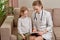 A doctor in a white coat tells the child what he is sick with. Family doctor.
