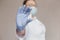 doctor in a white medical coat and gloves holds a coronovirus vaccine