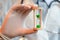 A doctor in white medical gloves holds an hourglass - a symbol of time to heal and cure. Close up