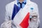 Doctor in white medical robe with monkeypox test tube and flag