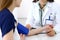 Doctor woman checking blood pressure of female patient, close-up. Cardiology in medicine and health care concept