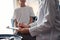 Doctor woman and kid patient at home. The pediatrician filling up medical form on clipboard, close up. Medicine