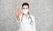 Doctor woman makes stopping hand gesture. Girl Doctor wearing protection face mask against covid-19. Banner panorama