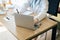 Doctor woman sitting and working on table using labtop and writing note at hospital