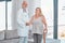 Doctor, woman and walking stick in portrait for rehabilitation, healthcare or wellness in consultation room. Medic