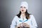 Doctor woman in white coat with dark hair in medical blue mask holds syringe in hands