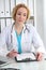 Doctor woman at work. Physician filling up medical history records form at the desk. Medicine, healthcare concept