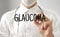 Doctor writing word GLAUCOMA with marker, Medical concept