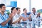 Doctors applauding while sitting at a table