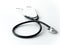 A doctors black flexible rubber and steel metal heart pulse stethoscope laying isolated on a white table top