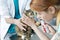 Doctors examining cat with otoscope equipment at veterinary clinic