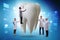 Doctors examining giant tooth in dental concept