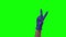 Doctors female hand in blue glove shows two fingers victory sign. Green screen. Close up