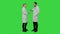 Doctors friends give each other five and thumb up on a Green Screen, Chroma Key.